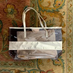 Clear tote with gold trim and hod cosmetic bag
